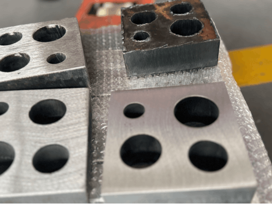A flat cut sample with external contours and internal openings that require consistent edge treatment